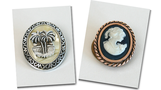 A pair of scarf clips featuring a palm tree and a cameo. A pair of scarf clips featuring a palm tree and a cameo.